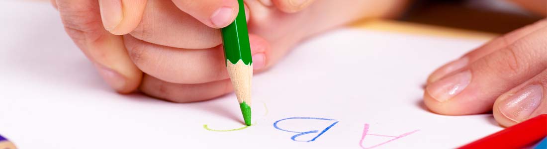 Preschooler writing alphabet